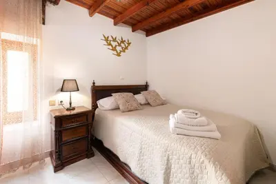 a bedroom with a bed and a table with a lamp at Sea La Vie Villa Symi in Symi