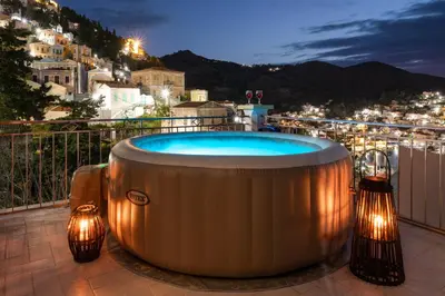 a hot tub on a balcony with lights at Sea La Vie Villa Symi in Symi