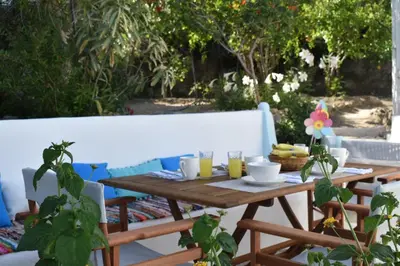a wooden table with cups and plates on it at Casa al mare in Archangelos