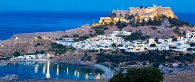 a village on a hill with a castle on top at Blue Line Villa Lindos in Líndos