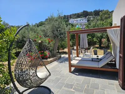 a patio with a hammock and a swing at Galini View Apartments Lindos in Líndos