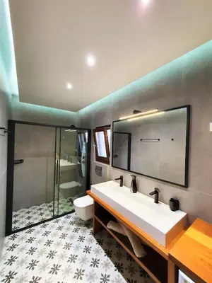 a bathroom with a large white sink and a shower at Galini View Apartments Lindos in Líndos