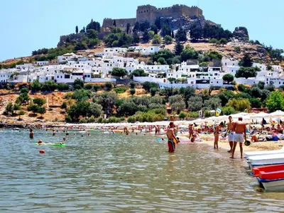 a group of people on a beach in the water at Galini View Apartments Lindos in Líndos
