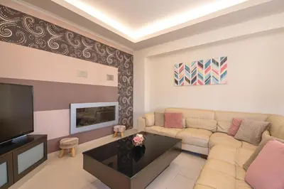 a living room with a couch and a television at Maria's Luxurious Villa in Koskinou in Koskinou