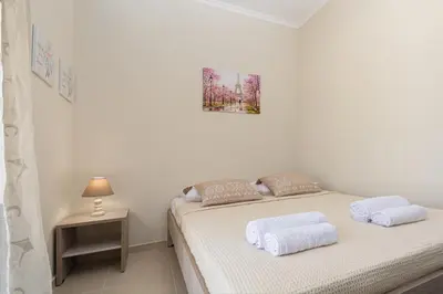 a white bedroom with a bed with two pillows at Maria's Luxurious Villa in Koskinou in Koskinou