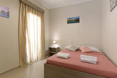 a bedroom with a bed with two towels on it at Maria's Luxurious Villa in Koskinou in Koskinou