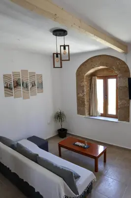 a living room with a couch and a table at Heliophilia Lindos in Líndos