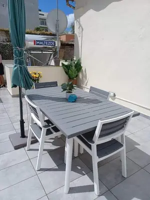 a wooden table and two chairs on a patio at Lolos' house in Rhodes Town