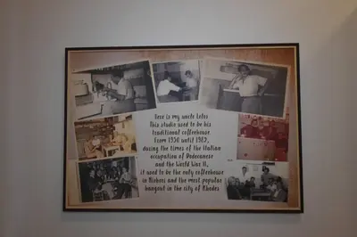 a picture hanging on a wall with photographs on it at Lolos' house in Rhodes Town