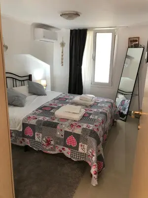 a bedroom with a bed with a quilt on it at Casa Fiore, Rhodes in Rhodes Town