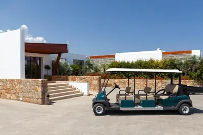 a golf cart parked in front of a building at LINDOS GARDENS RESORT COMPLEX in Líndos