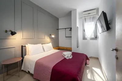 a small bedroom with a bed with a purple blanket at Wonderview Exclusive Apartment in Kremasti