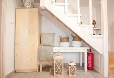 a stairway with a bench under the stairs at LUCA'S HOUSES in Halki