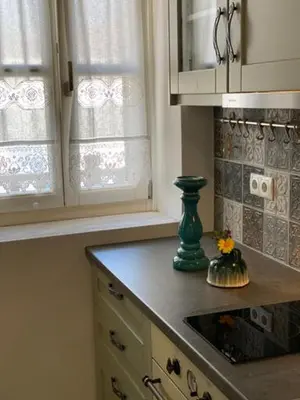 a kitchen with a green vase on a counter at LUCA'S HOUSES in Halki