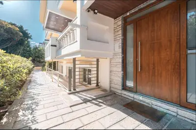 a house with a wooden door and a walkway at A&B Rhodes city apartments in Rhodes Town