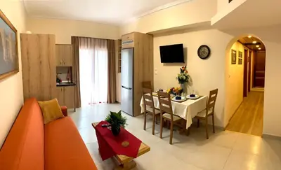 a living room with a table and a dining room at A&B Rhodes city apartments in Rhodes Town