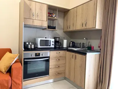 a small kitchen with a microwave and a stove at A&B Rhodes city apartments in Rhodes Town