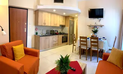 a living room with a kitchen and a dining room at A&B Rhodes city apartments in Rhodes Town