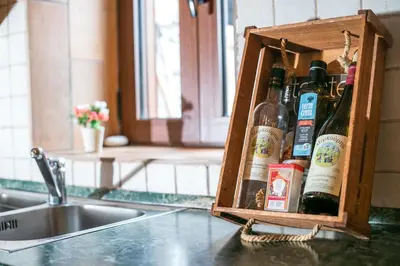 a wooden box filled with wine bottles sitting on a kitchen counter at Echo Traditional House - Ηχώ Παραδοσιακό Σπίτι in Émbonas