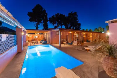 a swimming pool in the backyard of a house at night at Onar Villa Kolympia in Kolimbia