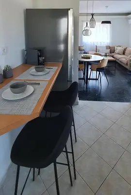 a kitchen and living room with a table and chairs at Rodos Beach Apartment 33 in Rhodes Town