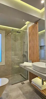 a bathroom with a glass shower and a sink at Rodos Beach Apartment 33 in Rhodes Town
