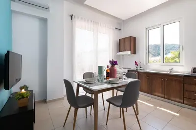 a kitchen with a table and chairs in a room at Rhodes Sea Ialysos Apartment in Ialyssos