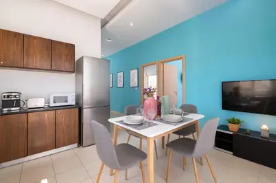 a kitchen with a table and chairs in a room at Rhodes Sea Ialysos Apartment in Ialyssos