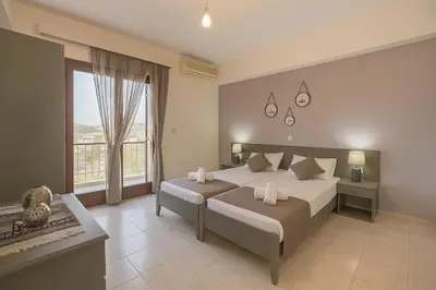 a bedroom with two beds and a large window at Rhodes Archaggelos Retreat-Nest Among Garden in Archangelos