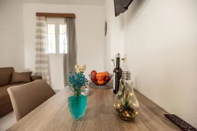 a wooden table with flowers in vases on it at Rhodes Archaggelos Retreat-Nest Among Garden in Archangelos