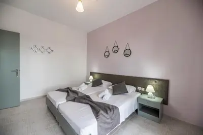 a bedroom with two beds with white sheets and pillows at Rhodes Archaggelos Retreat-Nest Among Garden in Archangelos