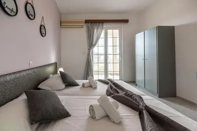 a bedroom with a large white bed with pillows at Rhodes Archaggelos Retreat-Nest Among Garden in Archangelos