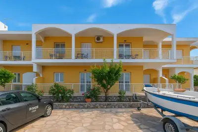a building with a car and a boat in front of it at Rhodes Archaggelos Retreat-Nest Among Garden in Archangelos