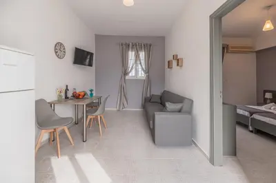 a living room with a couch and a table at Rhodes Archaggelos Retreat-Nest Among Garden in Archangelos
