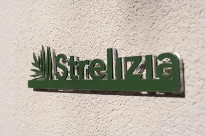 a green sign that says sirmila on a wall at Palmeral Luxury Suites in Rhodes Town