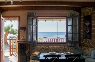 a living room with a couch and a view of the ocean at Villa Limnioni in Archangelos
