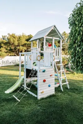 a playground with a slide and a play structure at M Mansion in Pefki Rhodes
