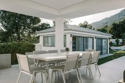 a white dining table and chairs on a patio at M Mansion in Pefki Rhodes