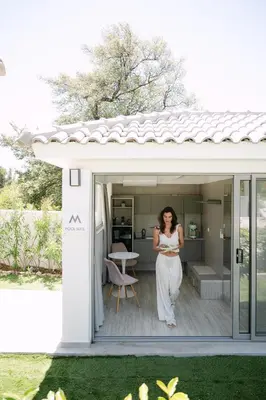 a woman standing in the doorway of a house at M Mansion in Pefki Rhodes
