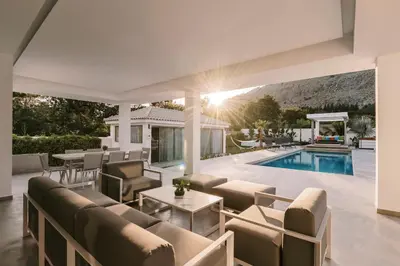 a living room with a couch and a pool at M Mansion in Pefki Rhodes