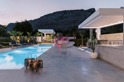 a swimming pool with baskets on the side of a house at M Mansion in Pefki Rhodes