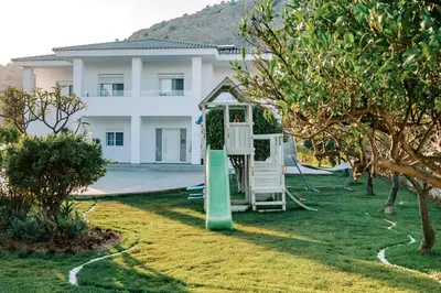 a playground in a yard in front of a building at M Mansion in Pefki Rhodes