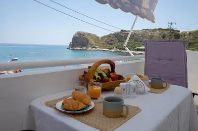 a table with a basket of food and a basket of fruit at stegna on sea apt in Archangelos
