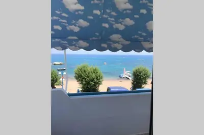a view of a beach through a window at stegna on sea apt in Archangelos