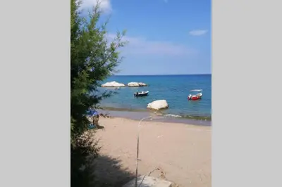 a view of a beach with boats in the water at stegna on sea apt in Archangelos