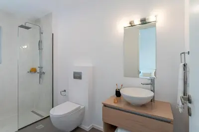 a bathroom with a toilet and a sink and a shower at Nora Villa in Afantou