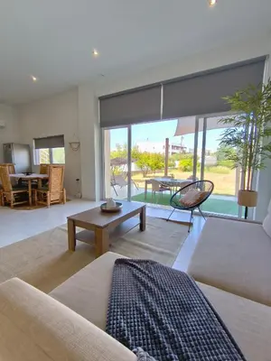 a living room with a couch and a table at Spacious Beach House Theologos in Theologos