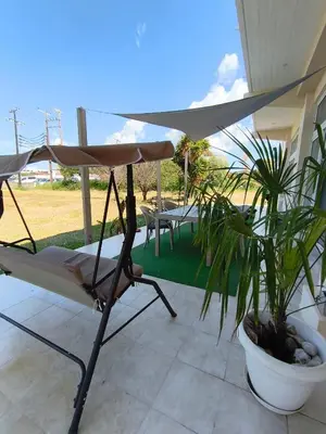 a chair and an umbrella on a patio at Spacious Beach House Theologos in Theologos