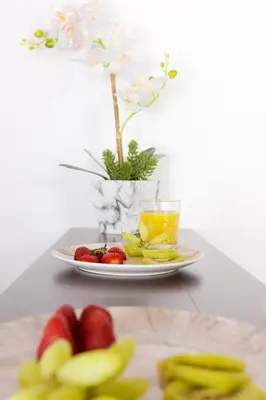 a plate of fruit and a glass of orange juice at Paraskevi Luxury Apartments in Kattavía