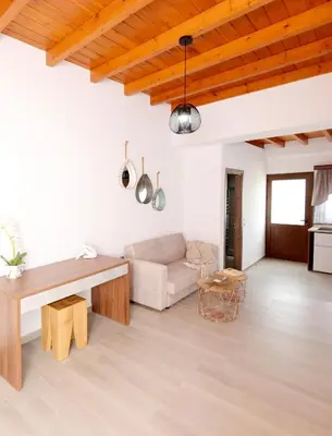 a living room with a couch and a table at Paraskevi Luxury Apartments in Kattavía